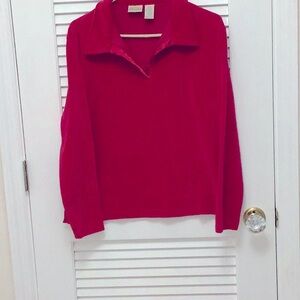Women’s Red Top. Long sleeves.. Has a collar the shape opening.